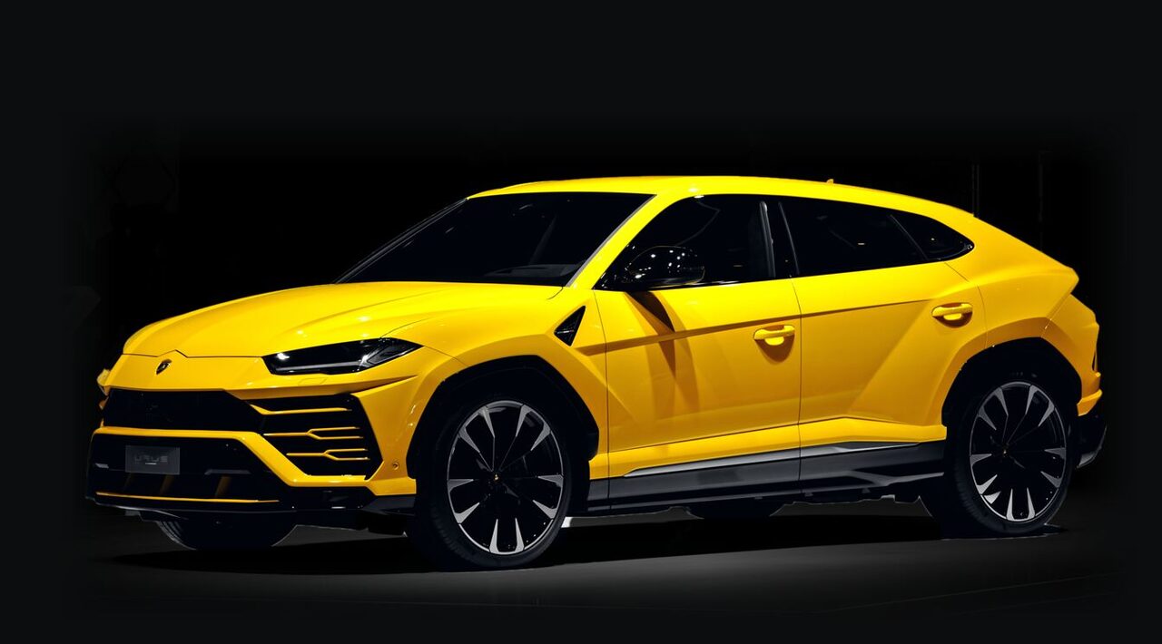 Lamborghini Urus amarelo visto de lado, sobre fundo preto